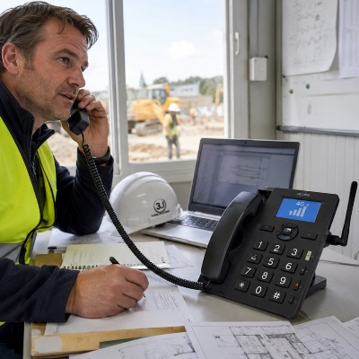 4G vaste telefoon met SIM-kaart gebruikt op een bouwplaats of tijdelijk kantoor